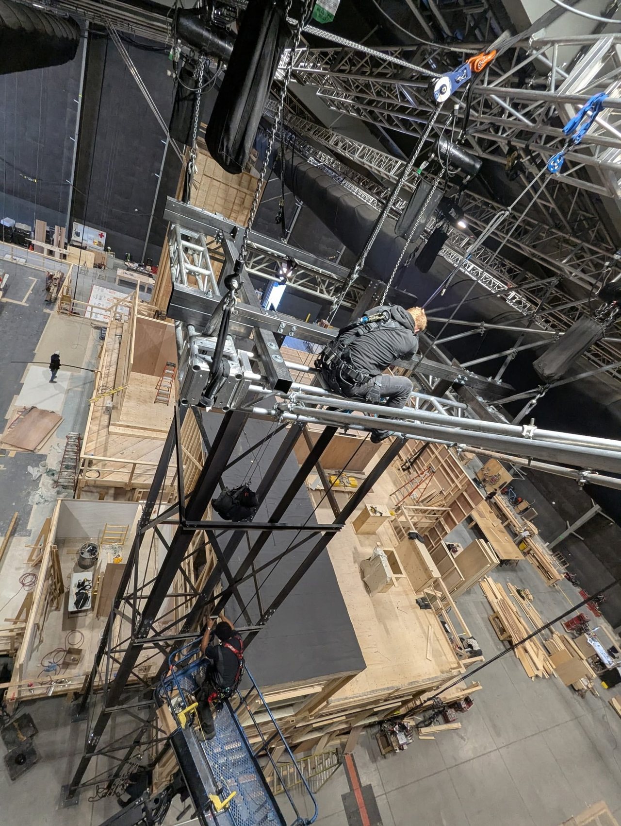 Two riggers working above the studio tower.